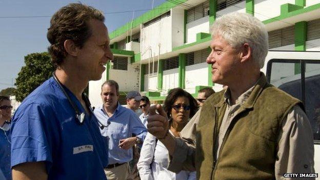 UN Special Envoy to Haiti former US President Bill Clinton speaks to a doctor at the General Hospital in downtown Haiti