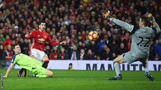 Liverpool keeper Simon Mignolet saves from Manchester United forward Henrikh Mkhitaryan