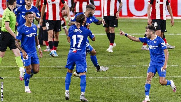 Ever Banega (centre, being lifted up) is congratulated by team-mates after scoring against Athletic Bilbao