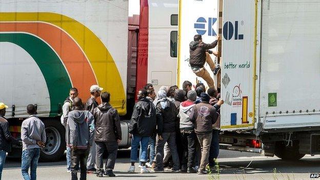 Immigrants getting into a lorry