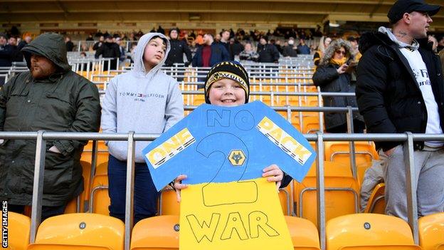 A young Wolves fan joins in the efforts to promote peace before Wanderers' Premier League game against Crystal Palace at Molineux