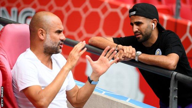 Pep Guardiola speaks to Riyad Mahrez before Sunday's Community Shield