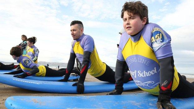 Nick Bright and teenagers on surf boards