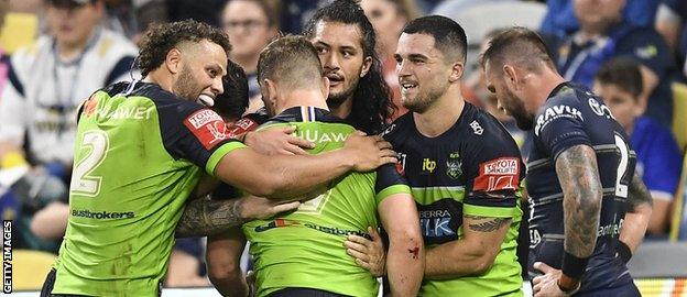 George Williams is mobbed by teammates after scoring at North Queensland Cowboys