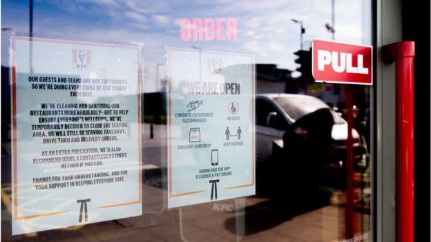 KFC window with sign on lockdown measures