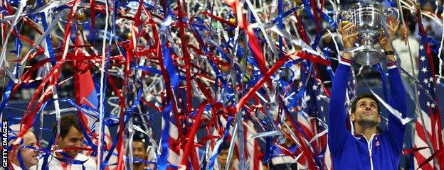 Novak Djokovic lifts the US Open trophy amid ticker tape