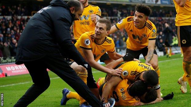 Wolves players and their manager Nuno Espirito Santo celebrate the winning goal against Leicester