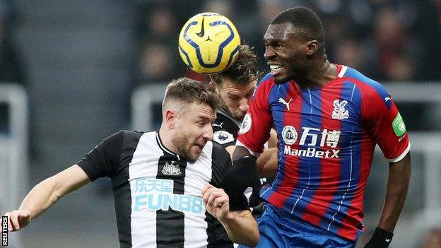 Paul Dummett challenges Christian Benteke