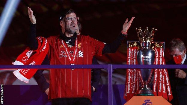 Jurgen Klopp next to the Premier League trophy
