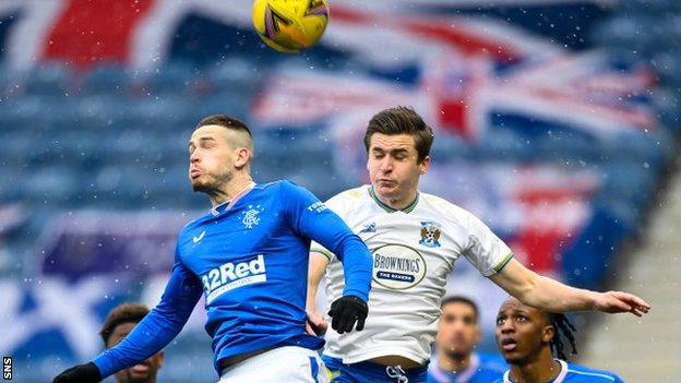 Rangers' Ryan Kent (left) rises for a high ball