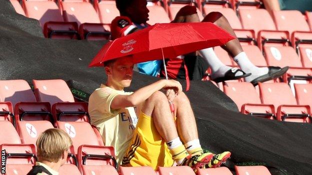 Mesut Ozil sitting in the stand while a substitute for Arsenal