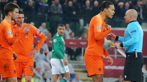 Virgil van Dijk protests to Polish referee Szymon Marciniak after he awarded Northern Ireland's first-half penalty