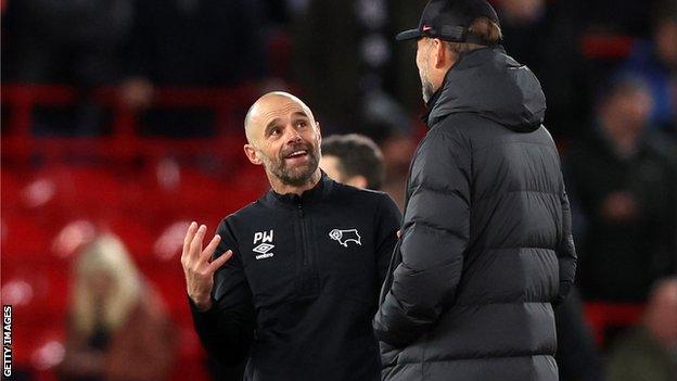 Derby boss Paul Warne (left) with Liverpool manager Jurgen Klopp