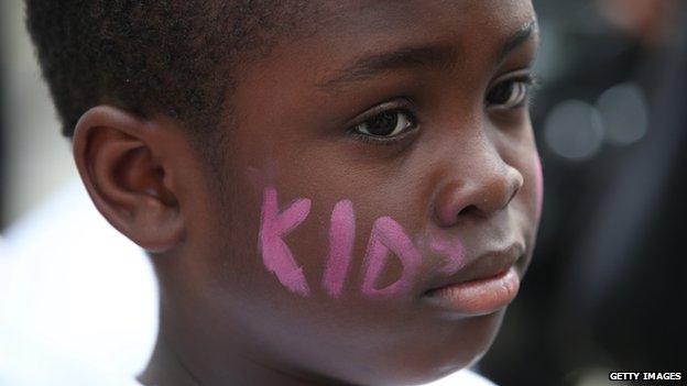 A child with Kids Company written on his cheeks