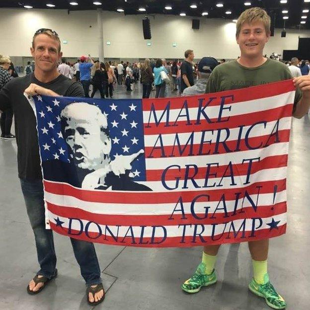 Eddie Gallagher holds a Make America Great Again flag