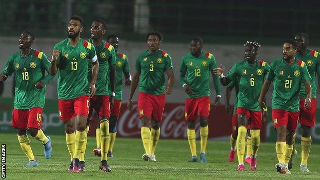 Cameroon players celebrate a goal against Algeria in March