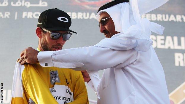 Mark Cavendish is presented with the race leader's jersey