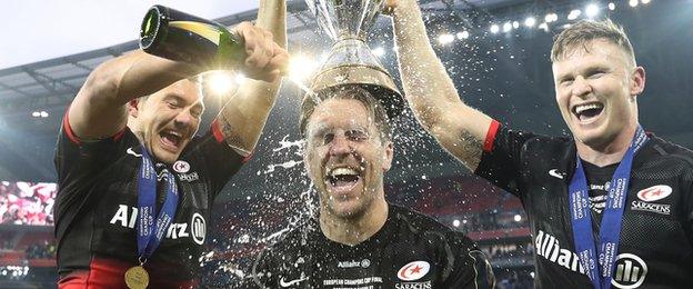 Alex Goode douses Chris Wyles in Champagne as a laughing Chris Ashton looks on