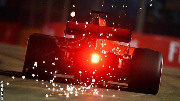 Sebastian Vettel drives in the distance at the Marina Bay Street Circuit