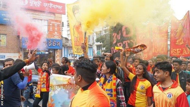 Fans make their way to the Salt Lake Stadium