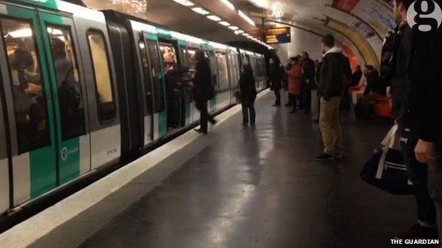 Image of a man being pushed off the Metro in Paris