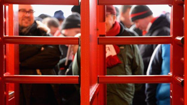 Generic shot of fans through turnstiles