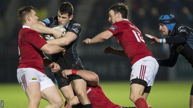 Glasgow Warriors' Mark Bennett (centre) is tackled by Rory Scannell (left) and Jaco Taute