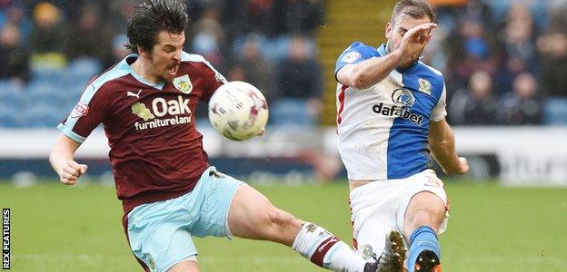 Joey Barton tackles Tommy Spurr of Blackburn Rovers while with Burnley