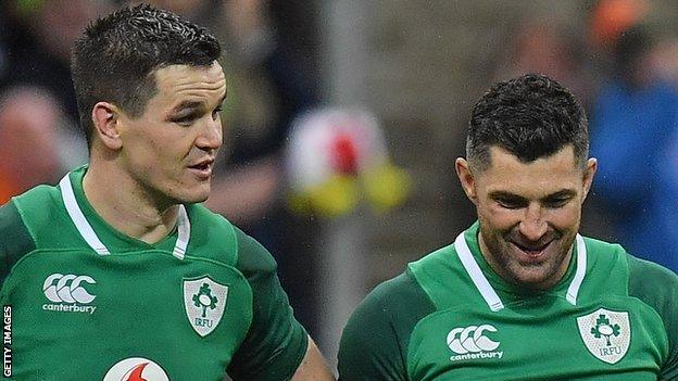 Rob Kearney smiles as Johnny Sexton makes a point after Ireland's win over France last year