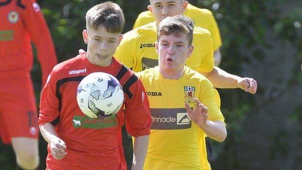 Antrim's Marc McKenna battles with Londonderry's Jack Malone at Anderson Park in Coleraine