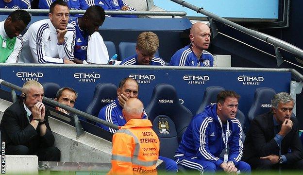 John Terry watches on from the subs' bench at Manchester City