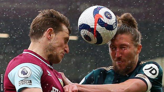 Burnley's Chris Wood battles for a header with Luke Ayling of Leeds United