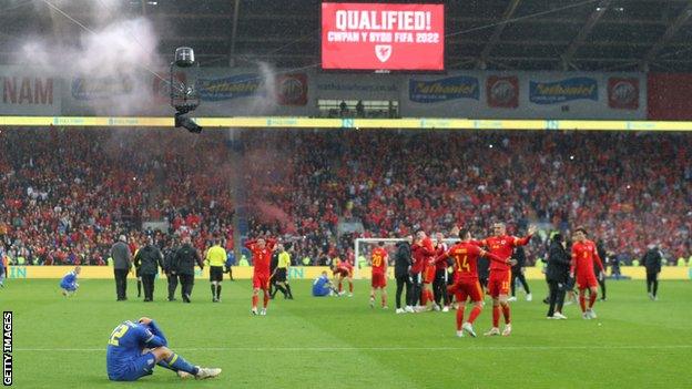 Mykola Matvienko of Ukraine looks dejected as Wales celebrate victory