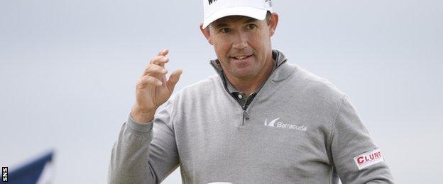 Padraig Harrington salutes the crowd after a successful putt