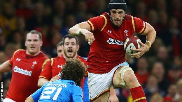 Luke Charteris leaps over a defender while playing for Wales against Italy