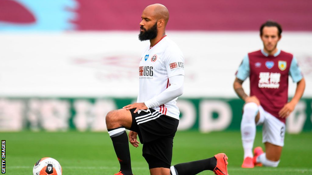 David McGoldrick takes a knee