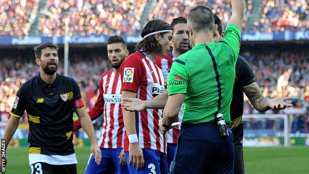 Seville defender Victor Vitolo is sent off against Atletico Madrid