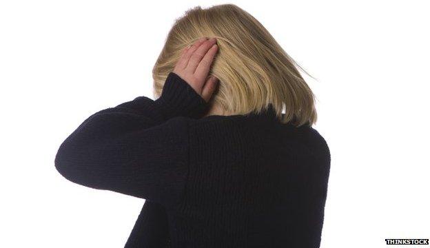 A portrait picture of a girl holding her hands over her ears