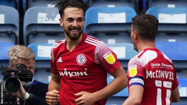 Accrington's Adam Phillips (left) celebrates his goal