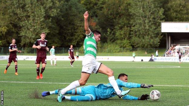 The New Saints" Aeron Edwards and Copenhagen goalkeeper Sten Grytebust battle for the ball