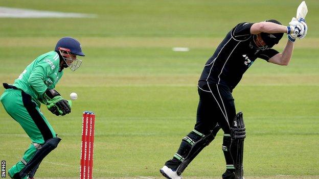 Ireland wicketkeeper Niall O'Brien attempts to collect the ball as Jimmy Neesham lets a delivery pass