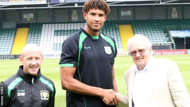 Yeovil manager Darren Way (left) and chairman John Fry shake on the deal with Omar Sowunmi