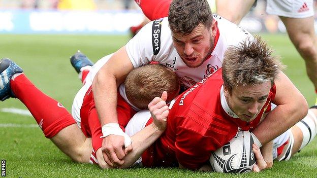 Angus Lloyd scores a try for Munster despite being challenged by Sean Reidy