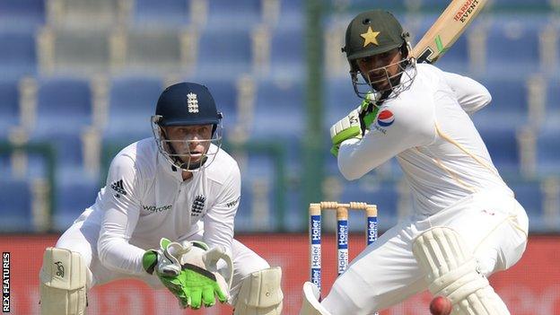 Jos Buttler stands at the wicket while Shoaib Malik hits out for Pakistan