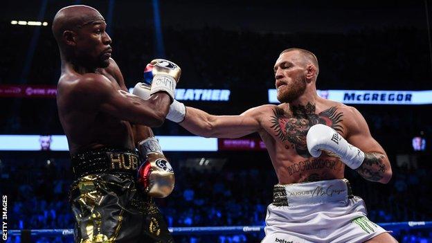 Floyd Mayweather dodges a punch from Conor McGregor