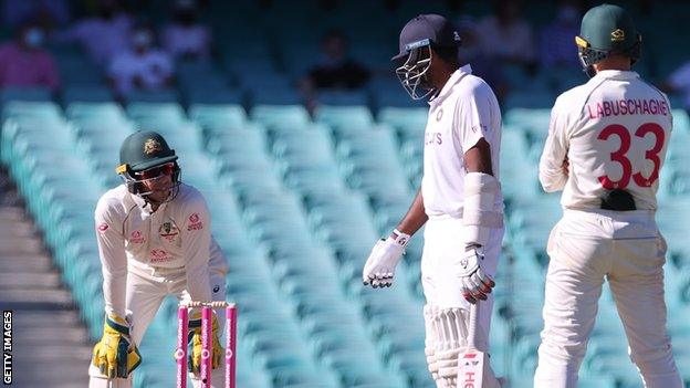 Australia captain Tim Paine (left) speaks to India's Ravichandran Ashwin (centre) during day five of the third Test in Sydney