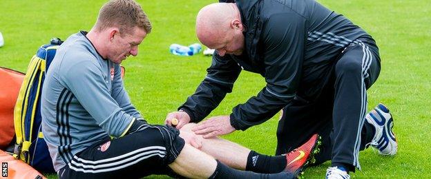 Aberdeen's Jonny Hayes receives treatment