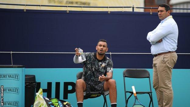 Kyrgios talks to a match official