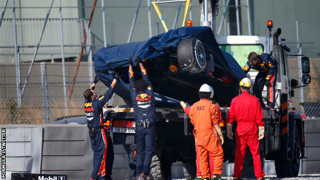 Pierre Gasly's Red Bull is lifted onto a recovery truck