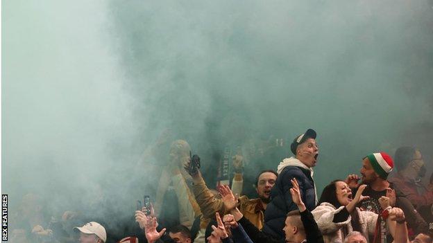 A flare goes off in the crowd in the Hungary section at Wembley